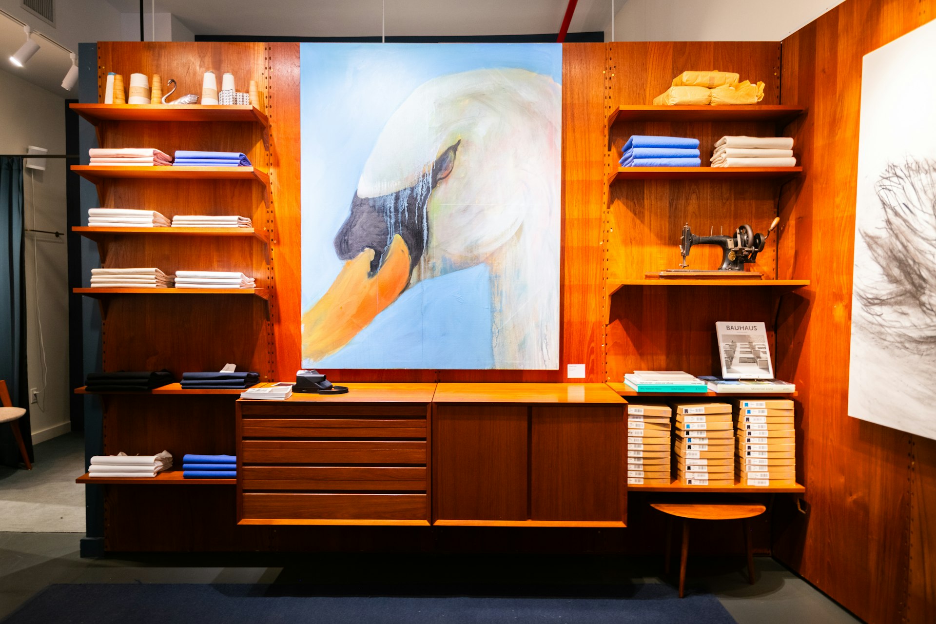Wooden wall unit with swan painting and books